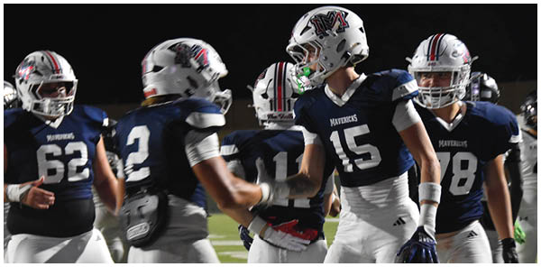 A group of football players on a field. Description generated by AI