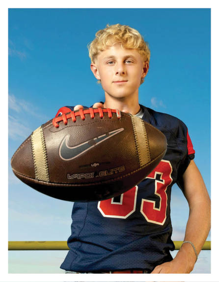 A football player wearing a blue and red jersey. Description generated by AI