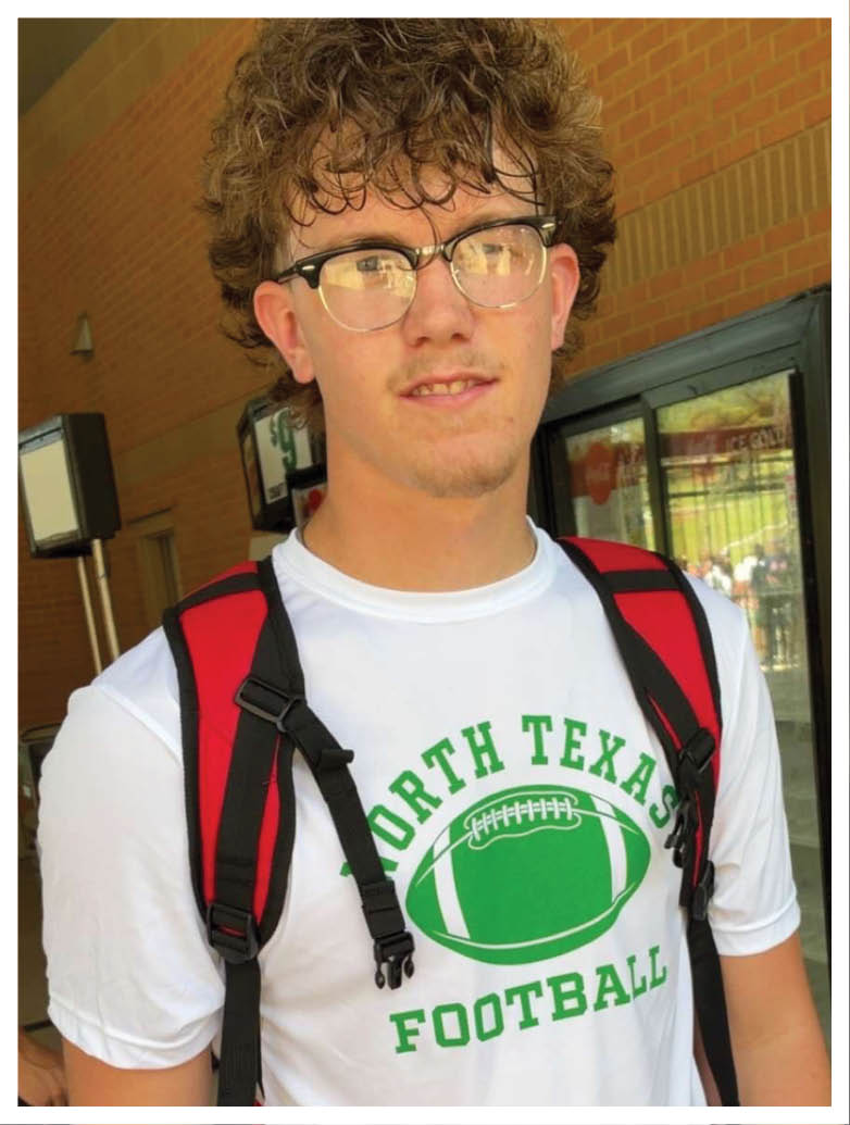 A football player wearing a blue and red jersey. Description generated by AI