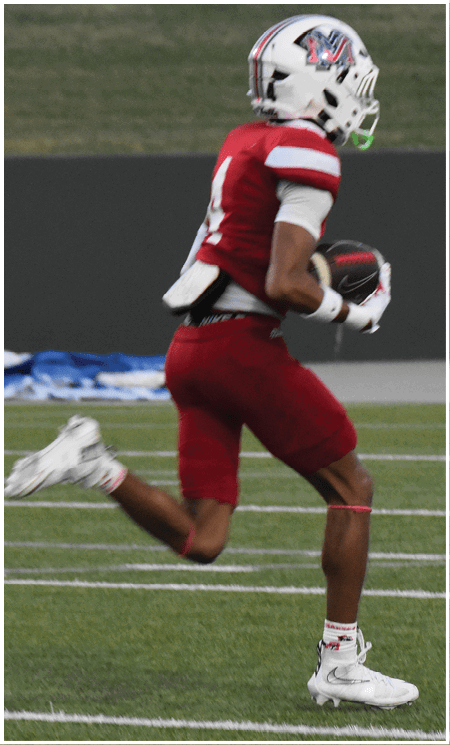 A group of football players celebrating a touchdown. Description generated by AI