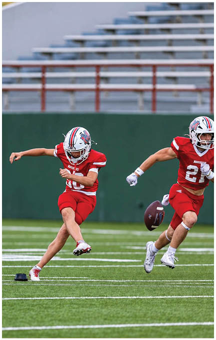 A football game is taking place with a group of men on the field. Description generated by AI