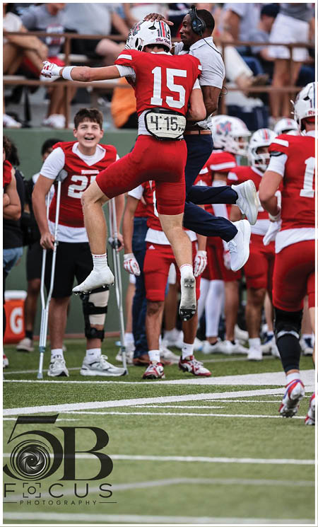 A group of football players celebrating a touchdown. Description generated by AI