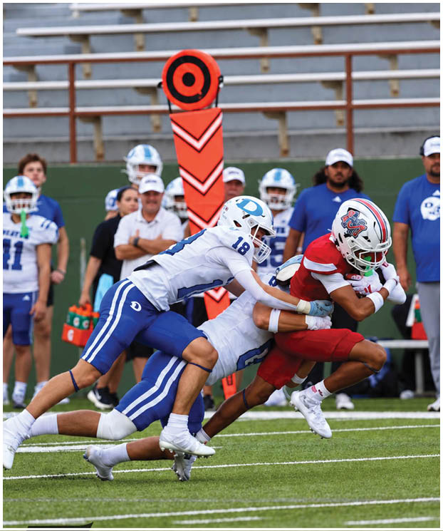 A group of football players on a field. Description generated by AI
