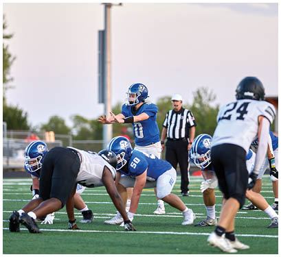 A group of football players on a field. Description generated by AI
