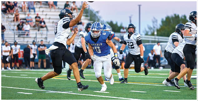 A football player wearing a blue jersey with the number 3 on it. Description generated by AI