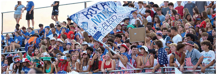 A group of people are sitting in the bleachers. Description generated by AI