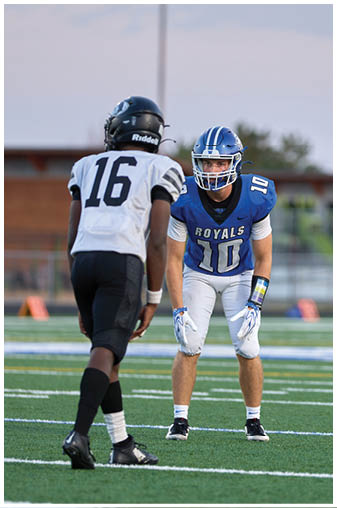 Two football players on a field. Description generated by AI