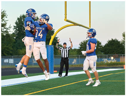 A group of football players celebrating a touchdown. Description generated by AI