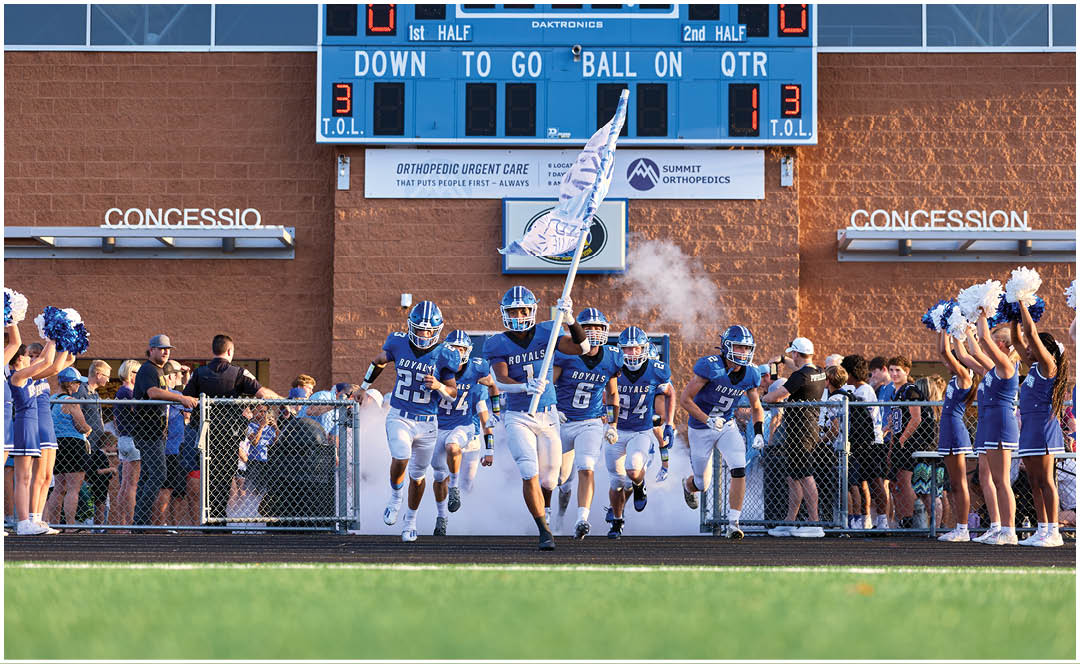 A group of football players on the field. Description generated by AI