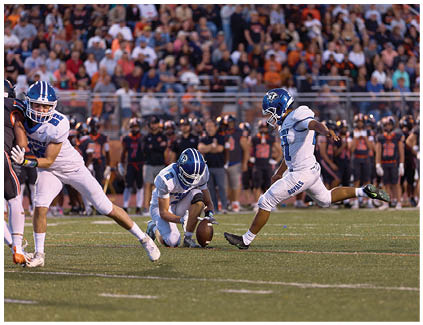 A football player is sliding on the ground. Description generated by AI