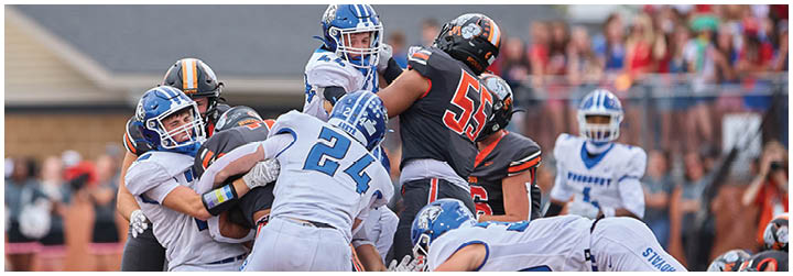 A group of football players on a field. Description generated by AI