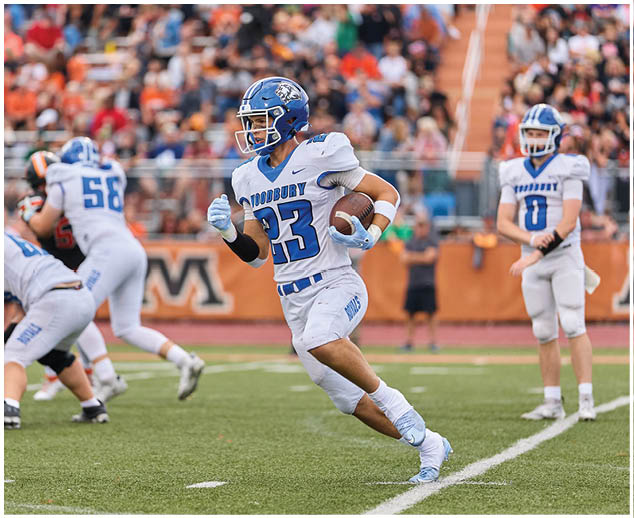 A football player running with the number 23 on his jersey. Description generated by AI
