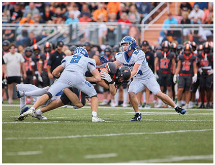 A football game is being played with a crowd watching. Description generated by AI