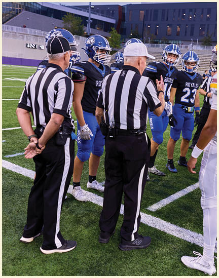 A group of football players on a field. Description generated by AI