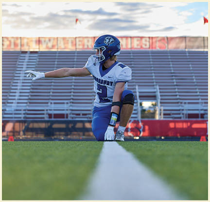 A football player is kicking a football on a field. Description generated by AI