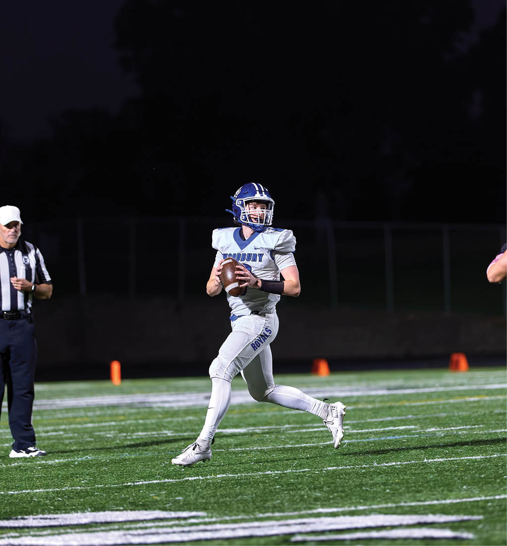 A football player in a white jersey with the number 16 on it. Description generated by AI