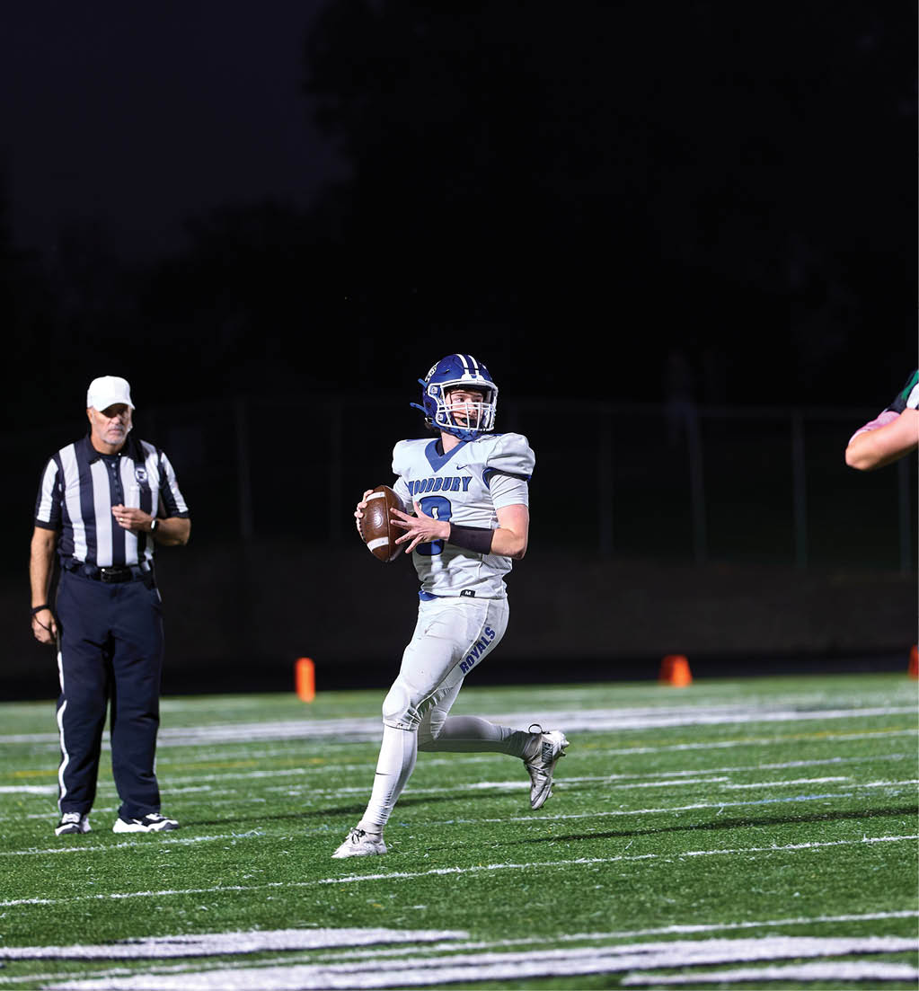 A football player in a white jersey with the number 16 on it. Description generated by AI
