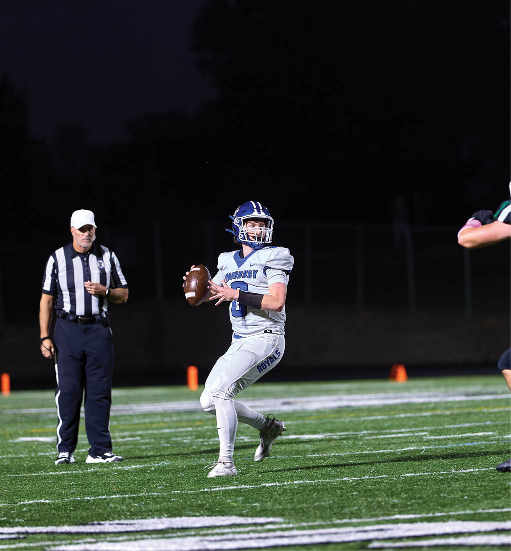 A football player in a white jersey with the number 16 on it. Description generated by AI