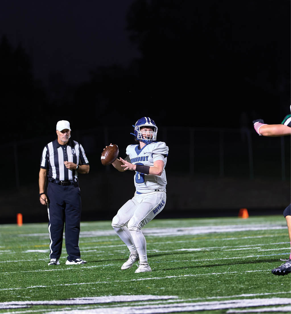 A football player in a white jersey with the number 16 on it. Description generated by AI