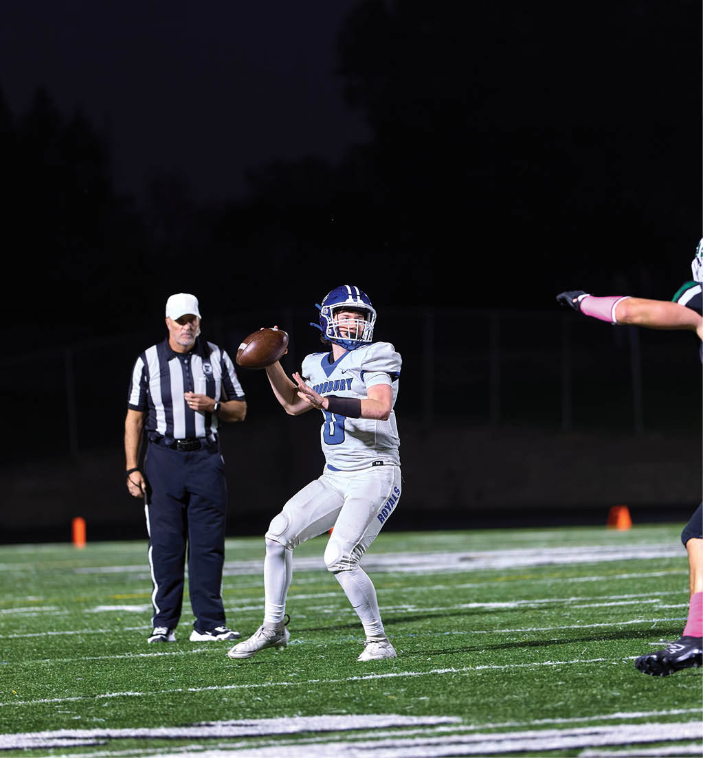 A football player in a white jersey with the number 16 on it. Description generated by AI