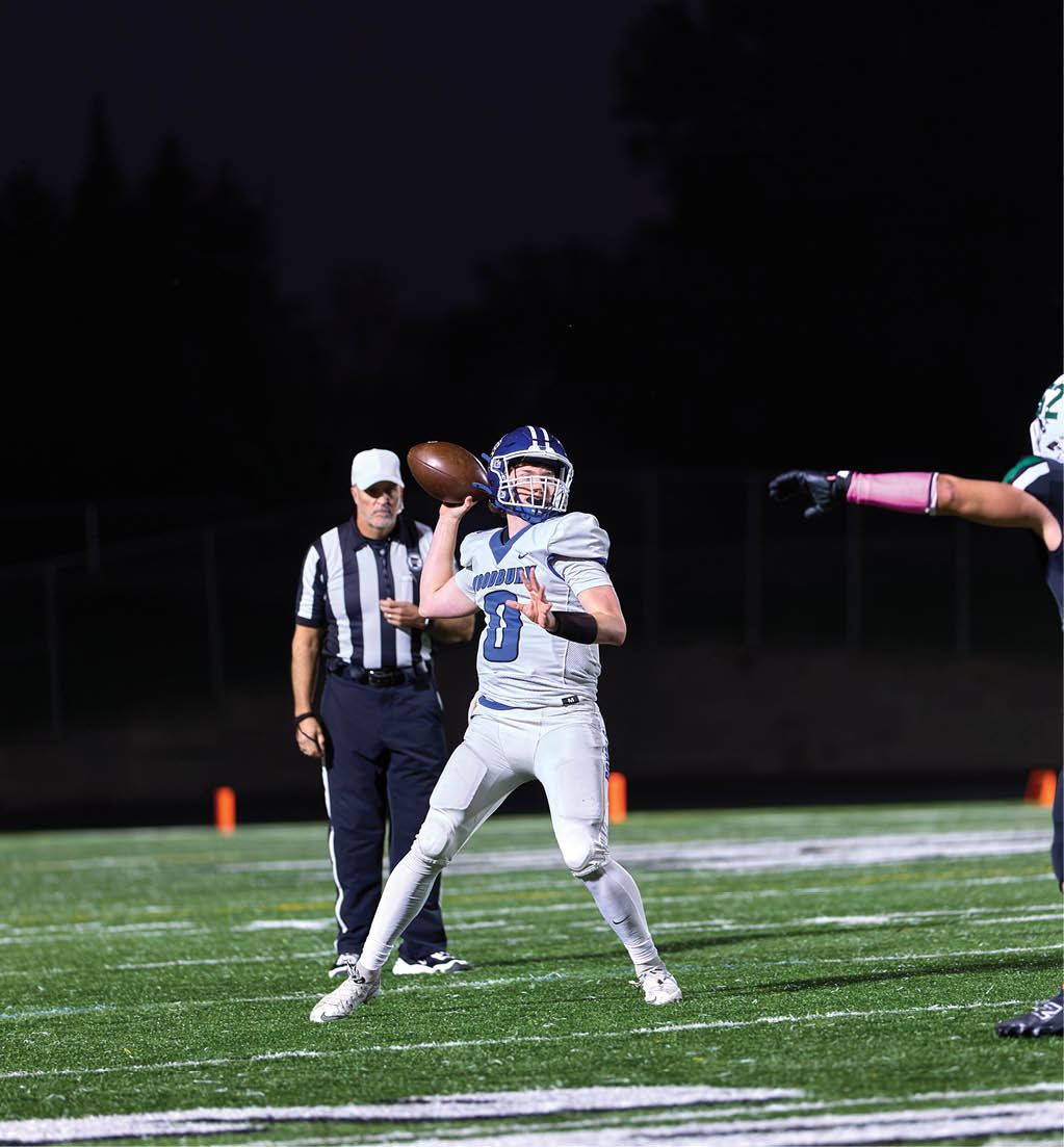 A football player in a white jersey with the number 16 on it. Description generated by AI