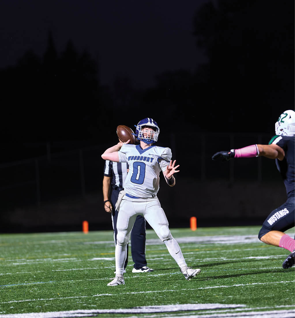 A football player in a white jersey with the number 16 on it. Description generated by AI