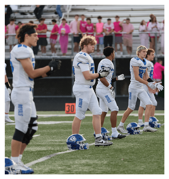 A group of football players walking on the field. AI generated content