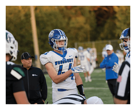 A man wearing a football uniform is jumping to catch a football. AI generated content