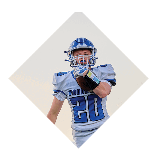 A female football player is kicking a football on a field. AI generated content