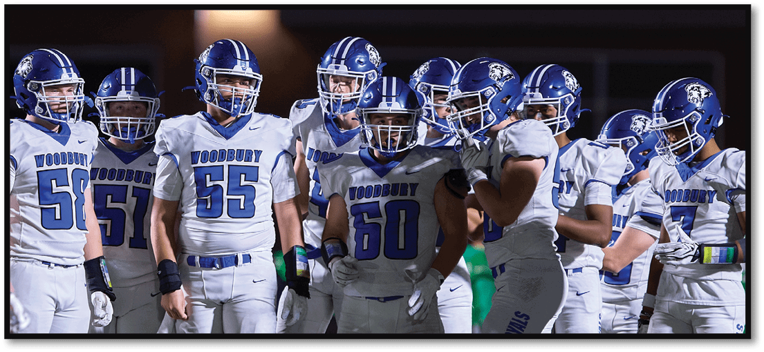 A group of football players on a field. Description generated by AI