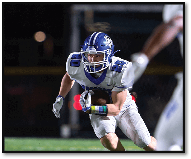 A football player is kicking a football on a field. Description generated by AI