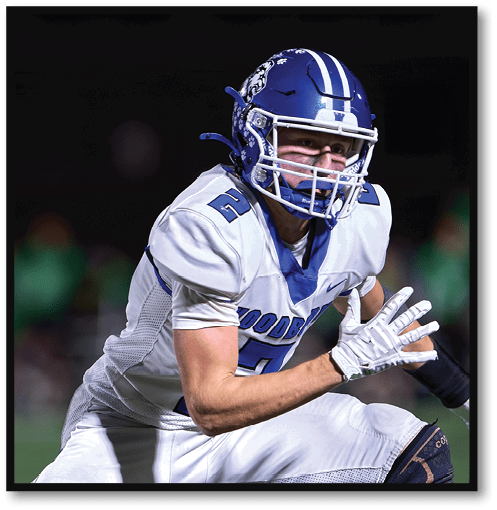 A football player wearing a black jersey with the number 6 on it. Description generated by AI