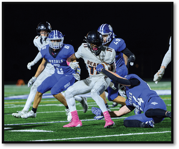 A group of football players wearing black jerseys with the number 3 on them. Description generated by AI