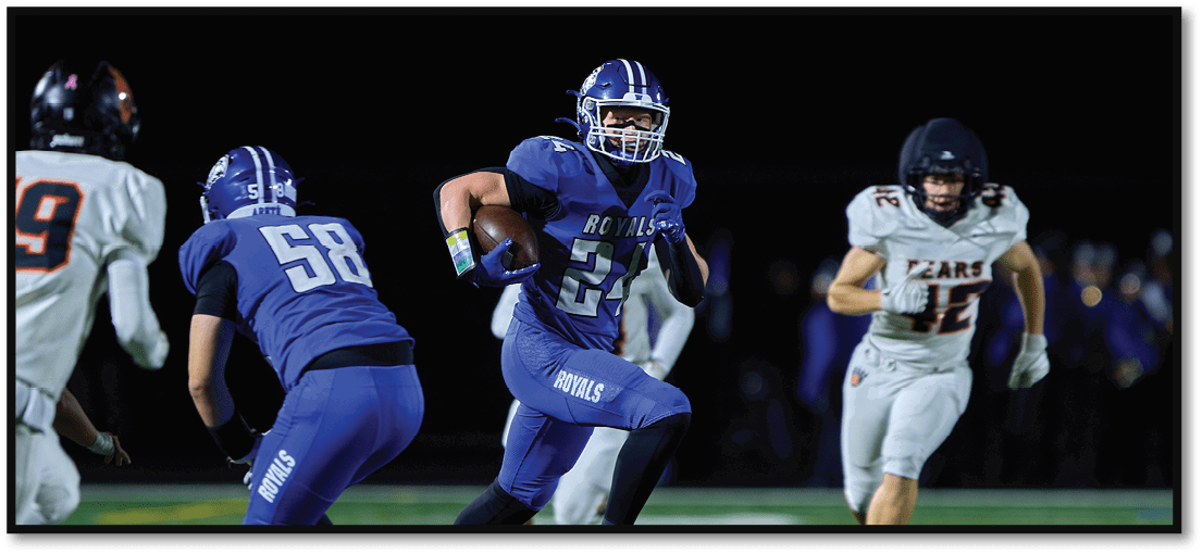 A group of football players on a field. Description generated by AI