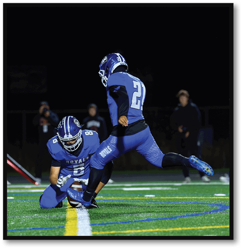 A football player wearing a black jersey with the number 6 on it. Description generated by AI