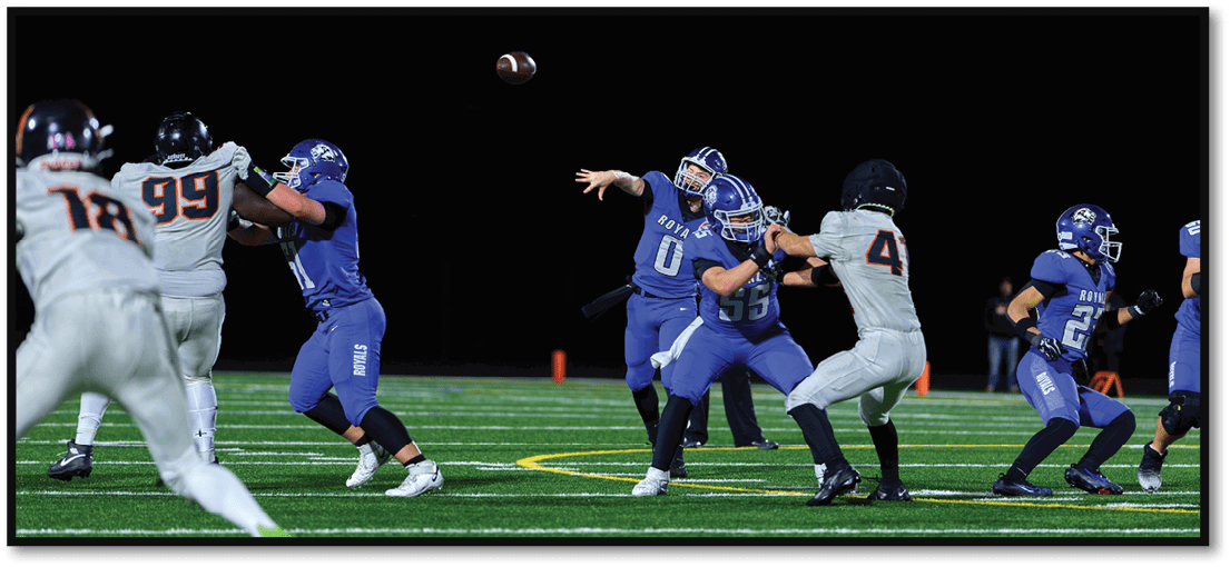 A group of football players on a field. Description generated by AI