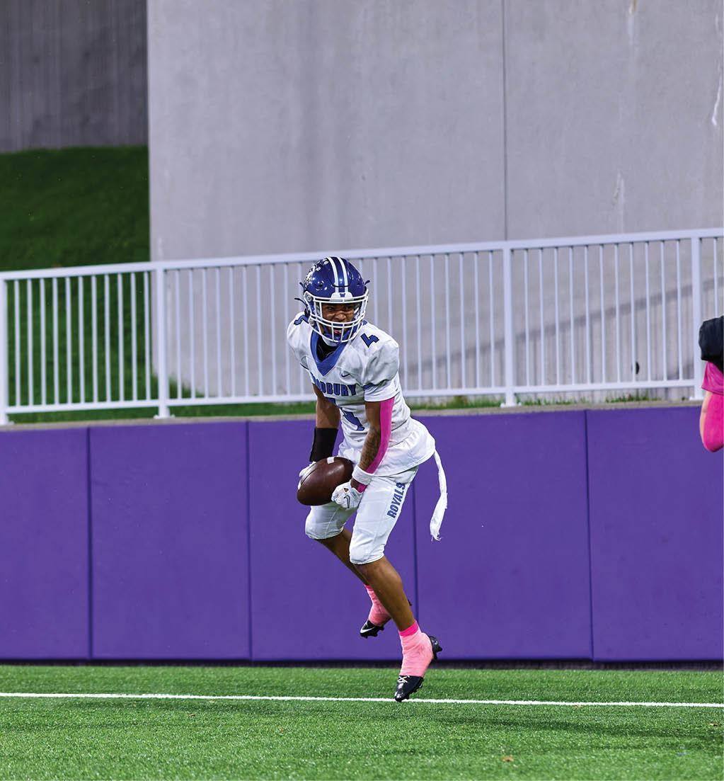 A football player in a white jersey with the number 16 on it. Description generated by AI
