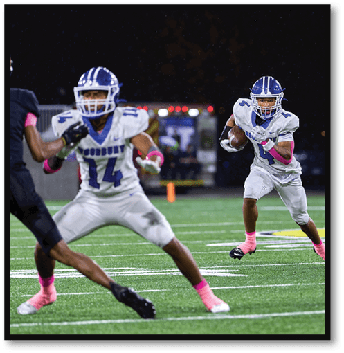 Two football players wearing black jerseys with the number 11 on them. Description generated by AI