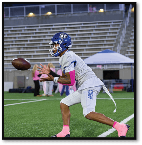 A football player wearing a black jersey with the number 6 on it. Description generated by AI