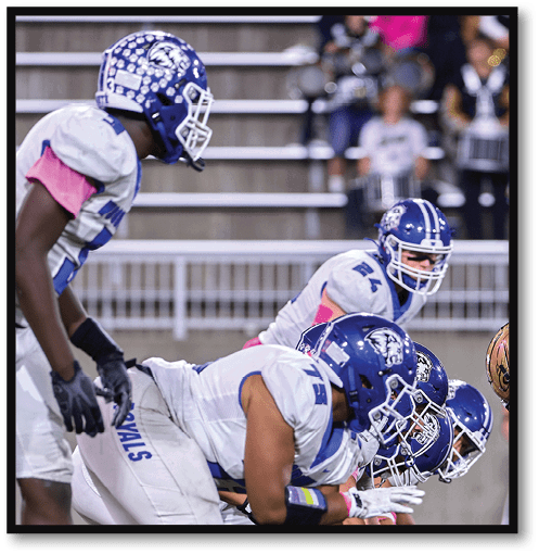 Two football players wearing black jerseys with the number 11 on them. Description generated by AI