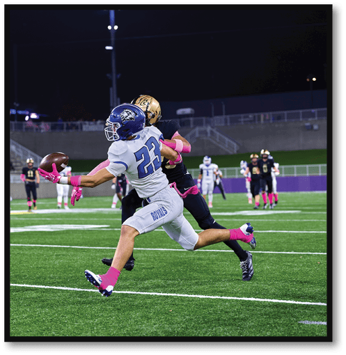 A football player wearing a black jersey with the number 6 on it. Description generated by AI