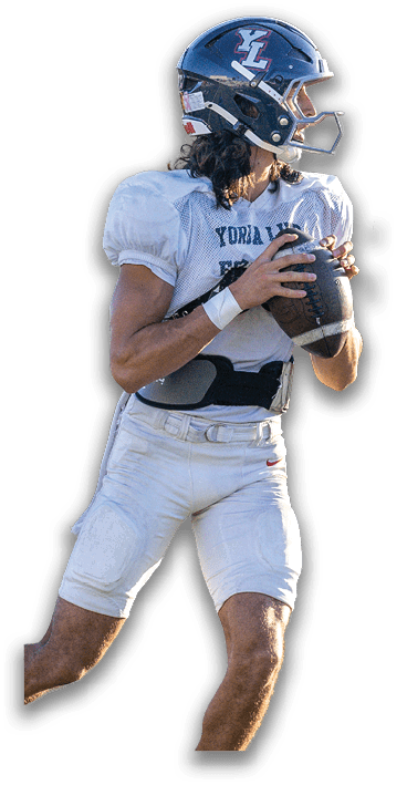 A person with curly hair is wearing a dark blue sports helmet with white and red lettering and a light blue shirt. Description generated by AI
