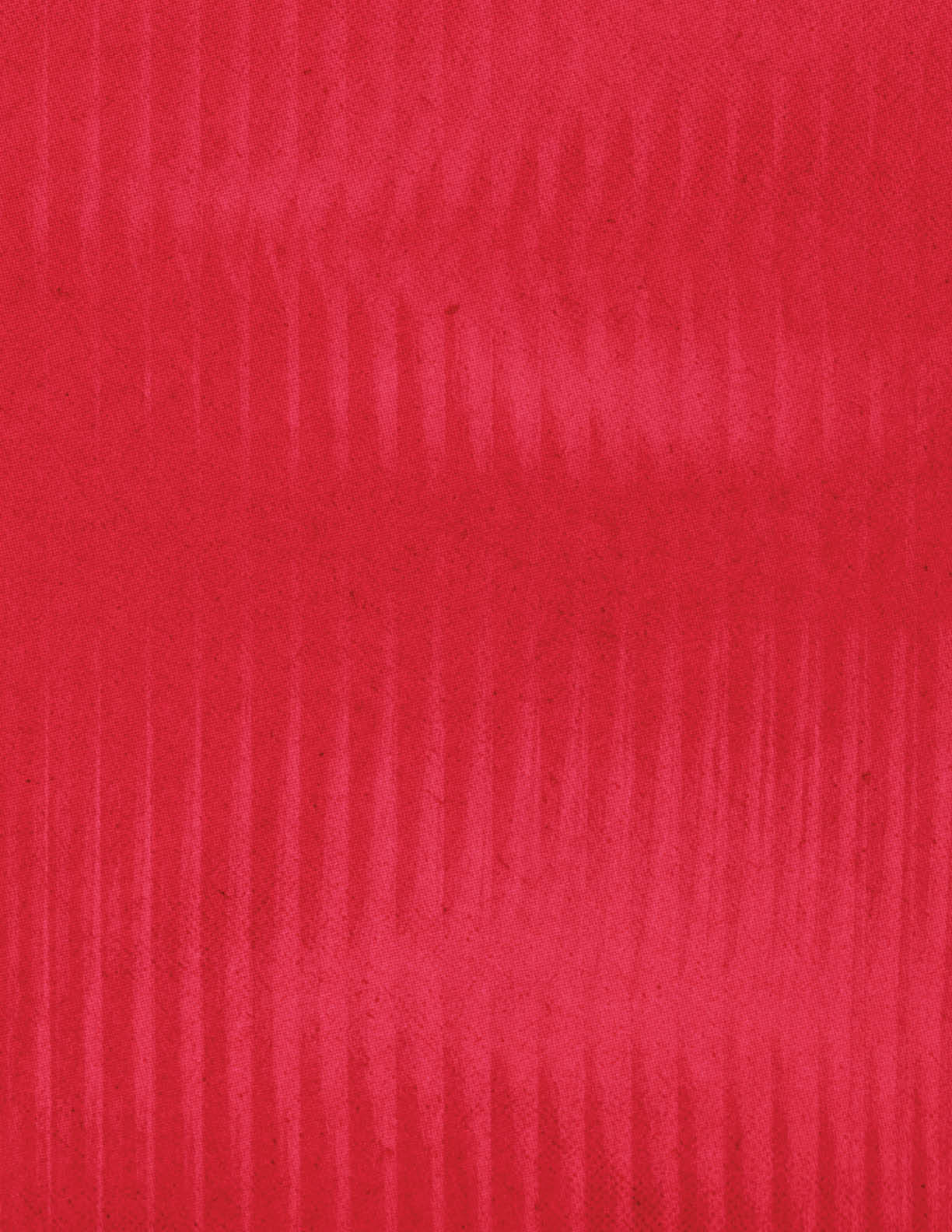 A close-up view of a red fabric with a subtle vertical ribbed texture. Description generated by AI