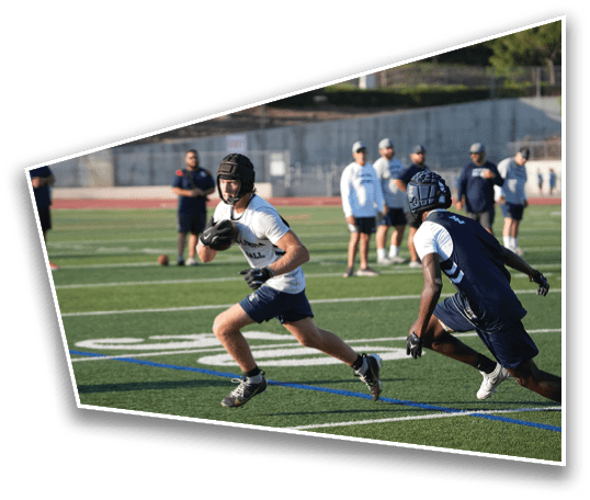 An adult wearing athletic clothing and gloves is running on a football field while holding a football. Description generated by AI