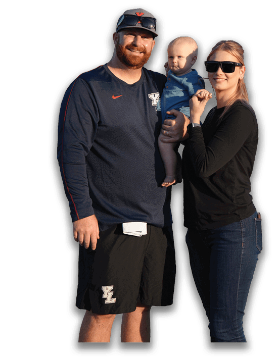 Two adults are partially visible at the bottom of the image, one wearing a cap with sunglasses resting on it. Description generated by AI