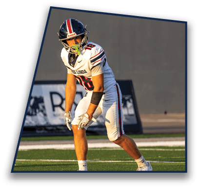 A person wearing a football helmet and white jersey with the number 18 is looking to the side against a plain background. Description generated by AI