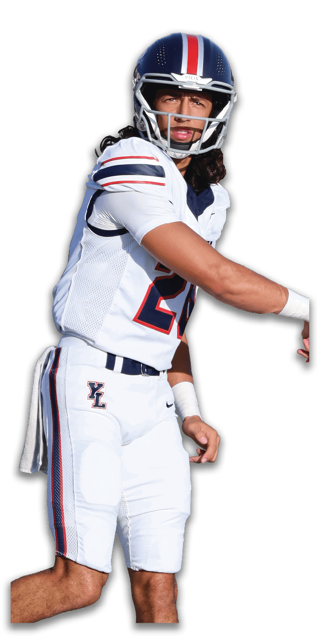 A person wearing a white football uniform with blue and red stripes and a helmet is in a throwing motion. Description generated by AI