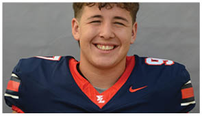 A close-up of a sports jersey collar with a red and navy blue color scheme and a white and red “YL" logo at the center. Description generated by AI