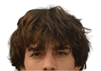 Person with medium-length hair wearing a navy blue and red Mustangs football jersey with the number 12 standing against a plain gray background. Description generated by AI