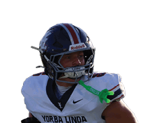 A person wearing a white football uniform with the number 5 is running on a green field during a game. Description generated by AI